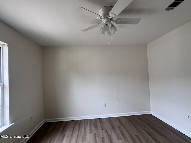 1620 Porpoise St, Ocean Springs, MS 39564 - empty room featuring dark wood-type flooring, baseboards, and ceiling fan