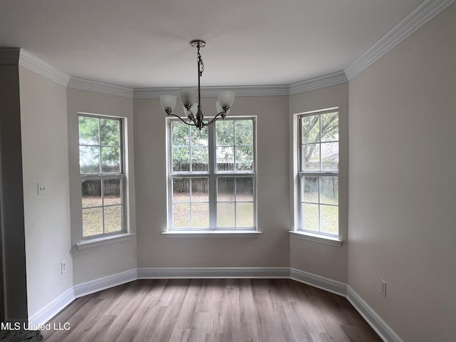 1620 Porpoise St, Ocean Springs, MS 39564 - unfurnished dining area featuring a chandelier, dark wood finished floors, baseboards, and ornamental molding