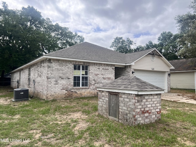 1620 Porpoise St, Ocean Springs, MS 39564 - rear view of property with an attached garage, roof with shingles, driveway, brick siding, and cooling unit