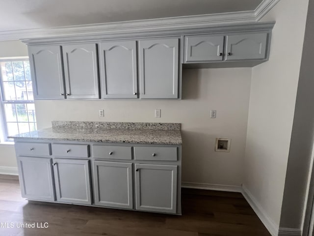 1620 Porpoise St, Ocean Springs, MS 39564 - kitchen featuring baseboards, dark wood-type flooring, gray cabinetry, light stone counters, and crown molding