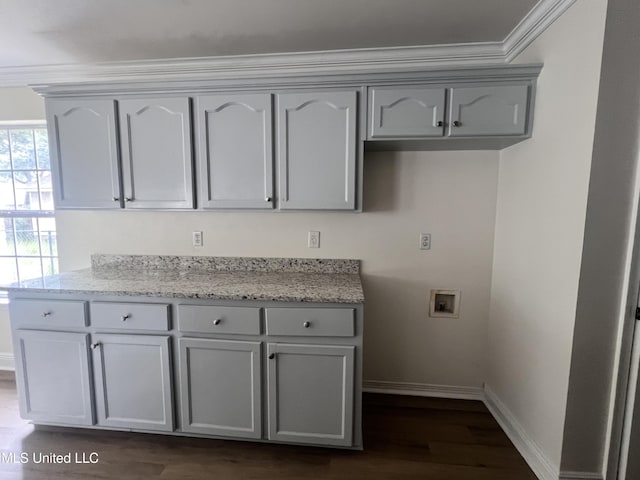 1620 Porpoise St, Ocean Springs, MS 39564 - kitchen featuring gray cabinetry, baseboards, dark wood finished floors, ornamental molding, and light stone countertops
