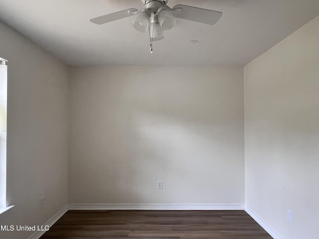 1620 Porpoise St, Ocean Springs, MS 39564 - empty room with dark wood-style floors, baseboards, and ceiling fan