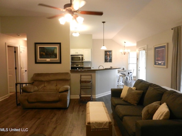 living area with dark wood-type flooring, vaulted ceiling, baseboards, and ceiling fan with notable chandelier