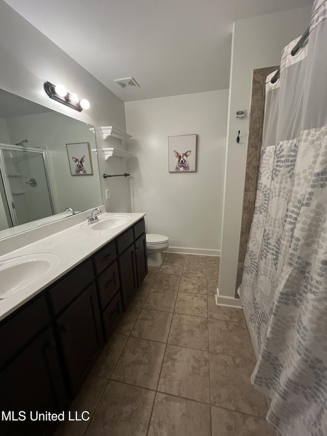 full bathroom with toilet, a stall shower, a sink, and visible vents