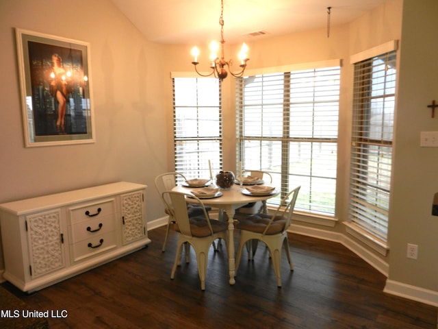 dining room featuring baseboards, dark wood finished floors, and a notable chandelier