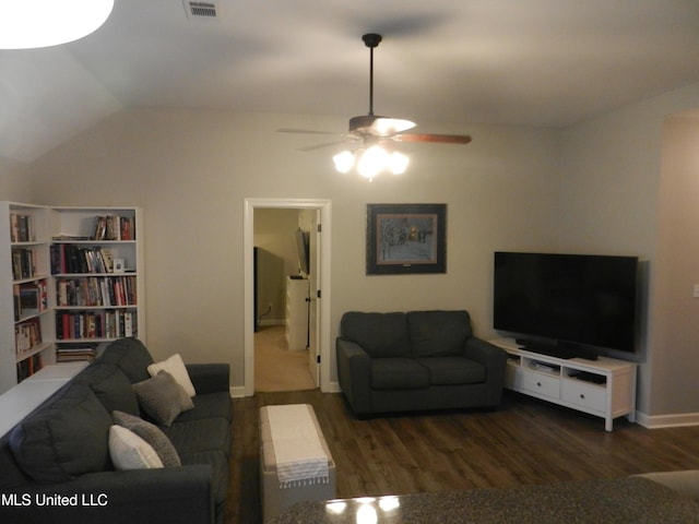 living area with baseboards, visible vents, ceiling fan, wood finished floors, and vaulted ceiling