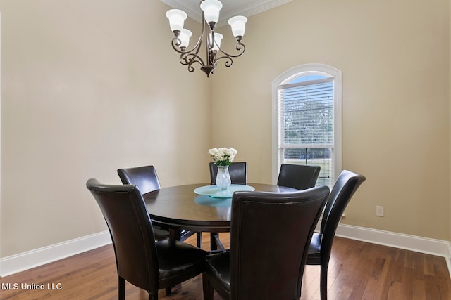 dining area with ornamental molding, a notable chandelier, and dark hardwood / wood-style flooring