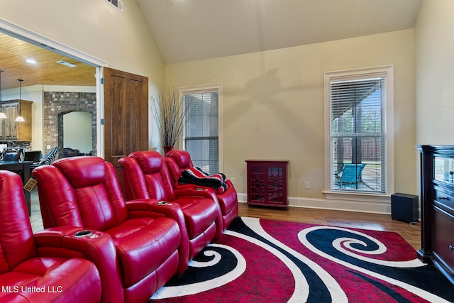 living room featuring hardwood / wood-style floors and high vaulted ceiling