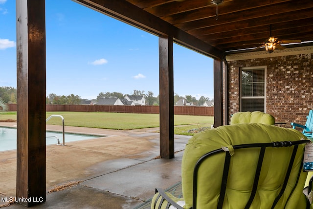 view of patio / terrace with a fenced in pool and ceiling fan