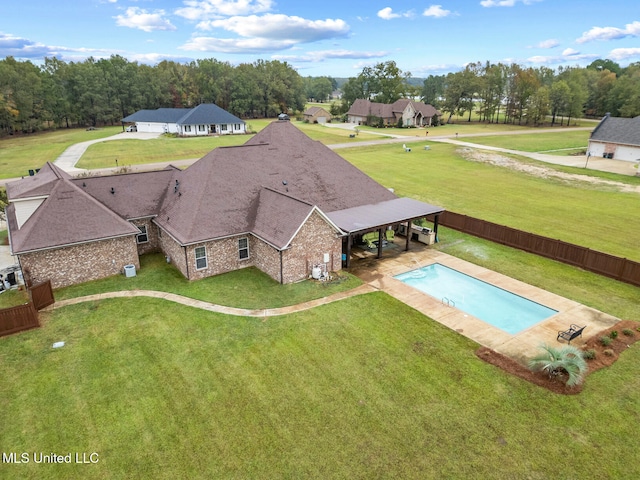 view of pool with a patio and a yard