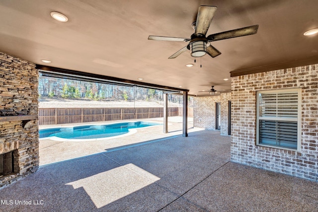 view of patio / terrace featuring ceiling fan and a fenced in pool