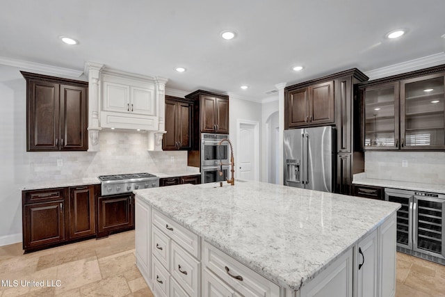 kitchen with a kitchen island, white cabinetry, wine cooler, and appliances with stainless steel finishes