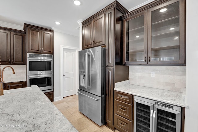 kitchen featuring tasteful backsplash, sink, dark brown cabinetry, stainless steel appliances, and wine cooler