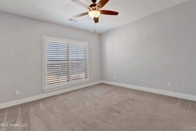 carpeted spare room with ceiling fan