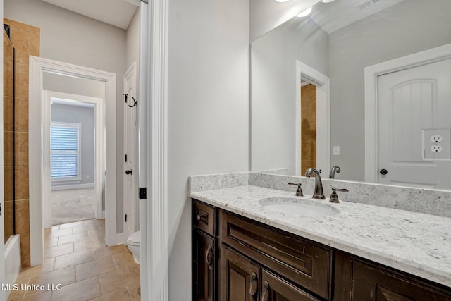 bathroom with vanity, toilet, and tile patterned floors