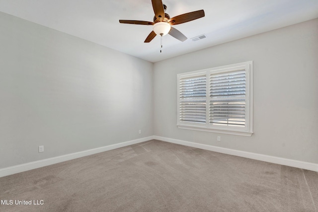 carpeted spare room featuring ceiling fan