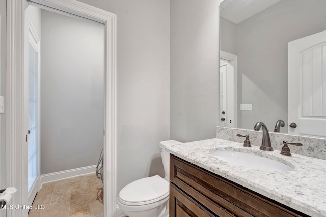 bathroom with toilet and vanity