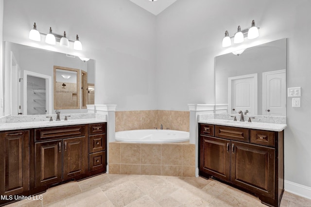 bathroom featuring vanity and shower with separate bathtub