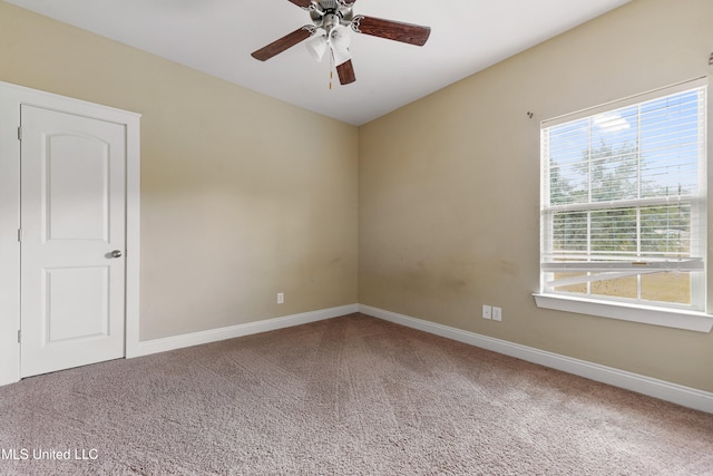 unfurnished room featuring ceiling fan and carpet floors