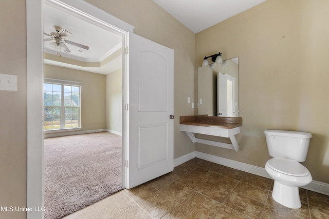 bathroom with toilet, crown molding, and ceiling fan