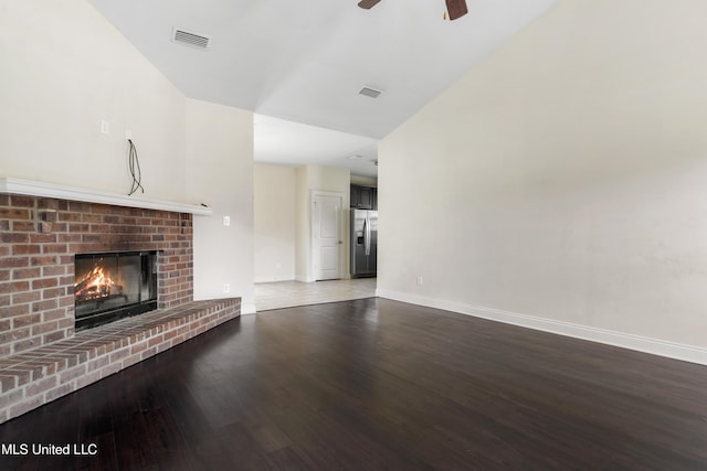 unfurnished living room with wood-type flooring, a fireplace, and ceiling fan