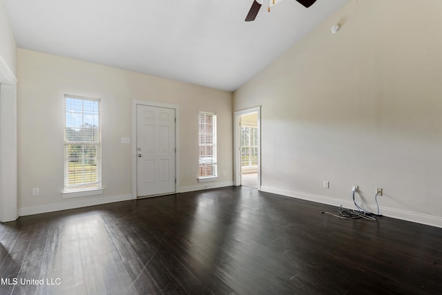 spare room featuring ceiling fan, high vaulted ceiling, a healthy amount of sunlight, and dark hardwood / wood-style flooring