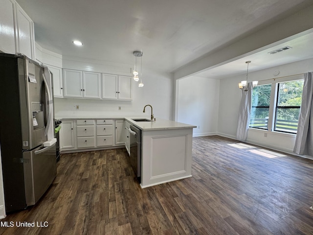 716 New Orleans St, Hattiesburg, MS 39401 - kitchen featuring stainless steel appliances, a peninsula, white cabinets, dark wood-type flooring, and light countertops