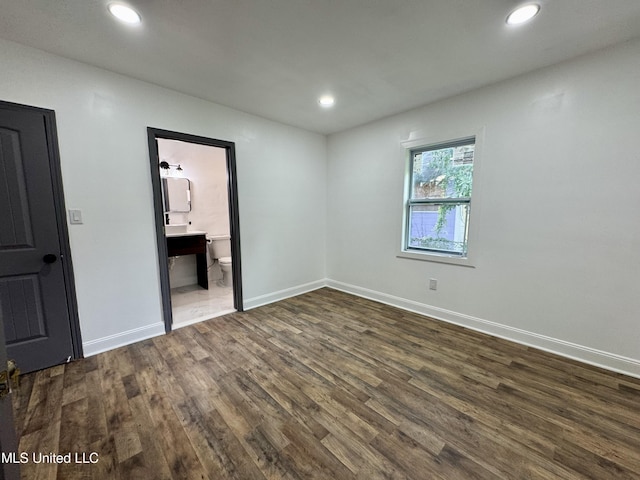 716 New Orleans St, Hattiesburg, MS 39401 - unfurnished bedroom with dark wood-style flooring, recessed lighting, and connected bathroom