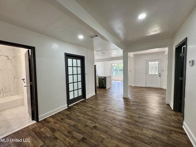 716 New Orleans St, Hattiesburg, MS 39401 - unfurnished living room with dark wood-style floors and recessed lighting