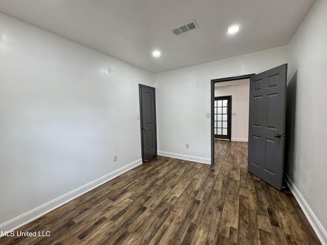 716 New Orleans St, Hattiesburg, MS 39401 - unfurnished bedroom featuring dark wood-type flooring and recessed lighting