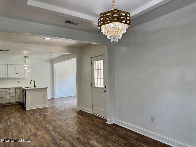 716 New Orleans St, Hattiesburg, MS 39401 - unfurnished living room featuring dark wood finished floors and a chandelier