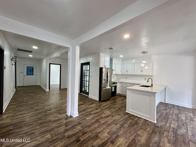 716 New Orleans St, Hattiesburg, MS 39401 - kitchen featuring stainless steel fridge with ice dispenser, a peninsula, range, dark wood-style floors, and white cabinets