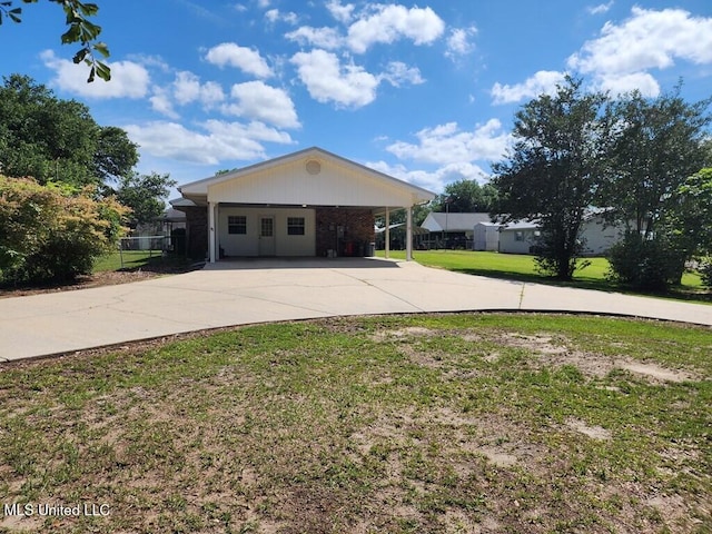 ranch-style home with a carport and a front yard