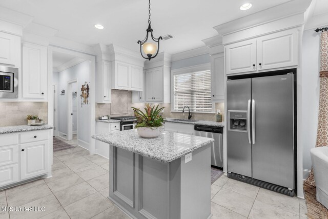 308 W Park St, Canton, MS 39046 - kitchen with stainless steel appliances, a sink, white cabinetry, crown molding, and backsplash