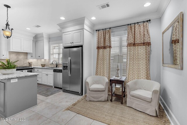 308 W Park St, Canton, MS 39046 - kitchen with stainless steel appliances, a sink, white cabinets, hanging light fixtures, and light stone countertops