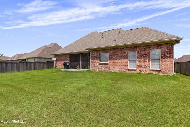 308 W Park St, Canton, MS 39046 - rear view of house with brick siding, a shingled roof, and a patio