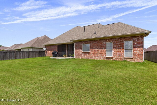 308 W Park St, Canton, MS 39046 - rear view of house with brick siding, a shingled roof, and a patio