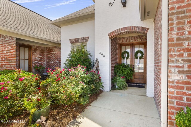 308 W Park St, Canton, MS 39046 - property entrance with brick siding, a shingled roof, and french doors