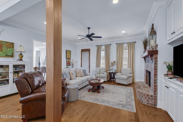 308 W Park St, Canton, MS 39046 - living area featuring a fireplace, ornamental molding, a ceiling fan, wood finished floors, and recessed lighting