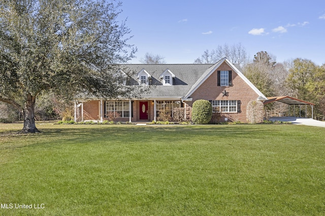 new england style home with brick siding, a carport, and a front yard