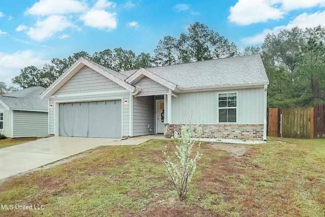 ranch-style house featuring a front lawn and a garage