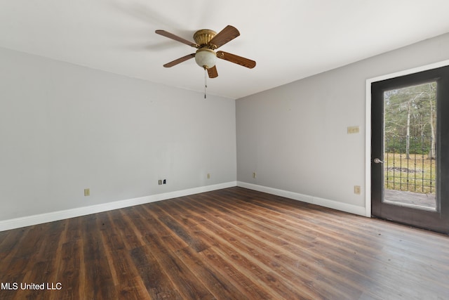 empty room featuring ceiling fan, a wealth of natural light, and dark hardwood / wood-style floors