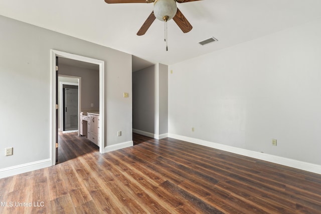 spare room featuring dark wood-type flooring and ceiling fan