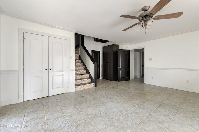 unfurnished living room with ceiling fan and crown molding