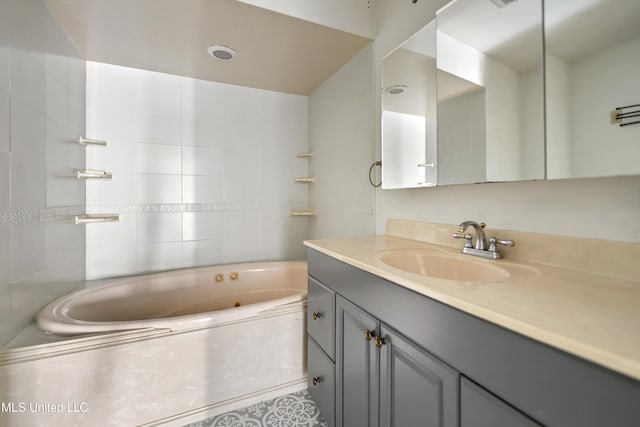 bathroom featuring a washtub and vanity