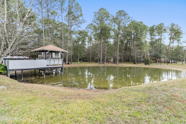 view of dock featuring a gazebo, a lawn, and a water view