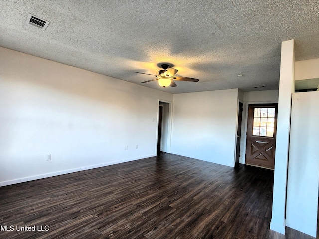 unfurnished room with a textured ceiling, dark hardwood / wood-style floors, and ceiling fan