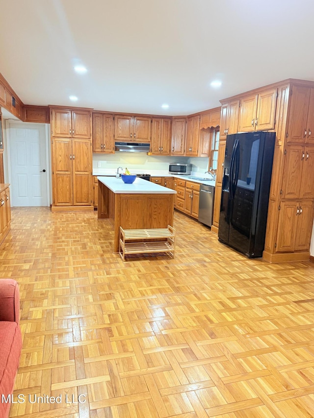 588 Robin Rd, Grenada, MS 38901 - kitchen with light parquet flooring, stainless steel appliances, and a kitchen island