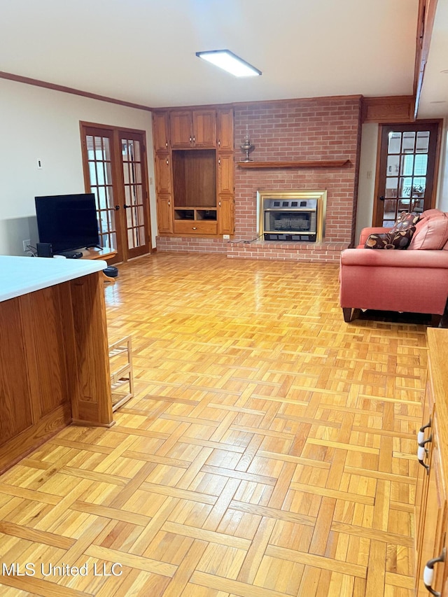 588 Robin Rd, Grenada, MS 38901 - living room with crown molding, a fireplace, french doors, and light parquet flooring