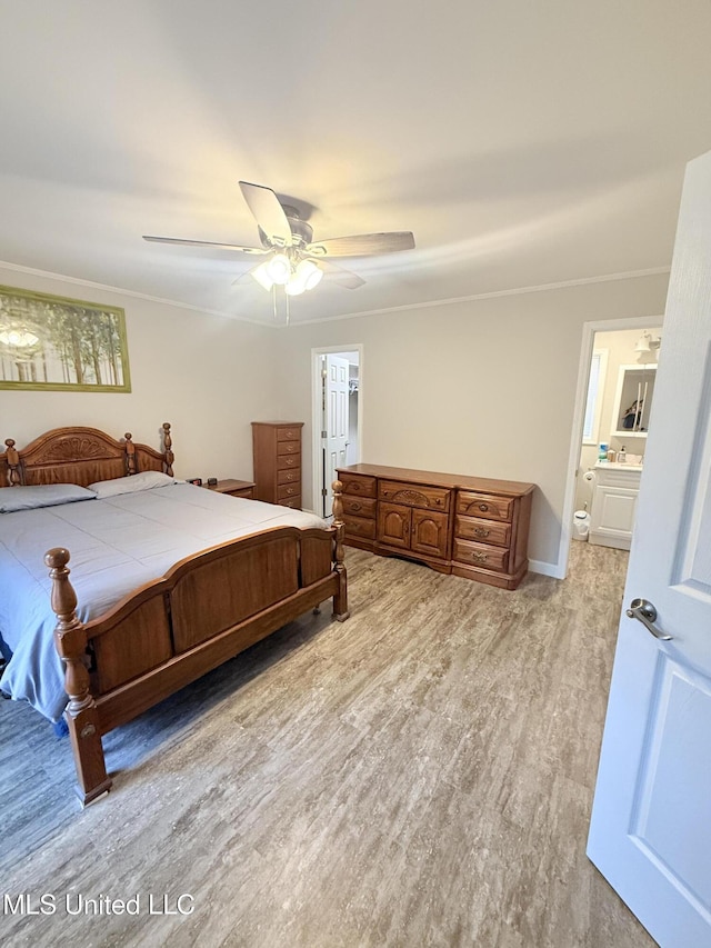 588 Robin Rd, Grenada, MS 38901 - bedroom with ensuite bath, light hardwood / wood-style flooring, ornamental molding, and ceiling fan